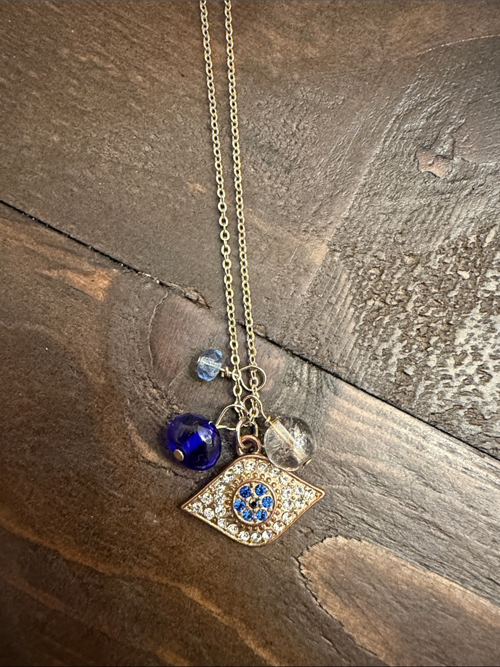 Gold Evil Eye Pendant Necklace with Blue Crystal Accents